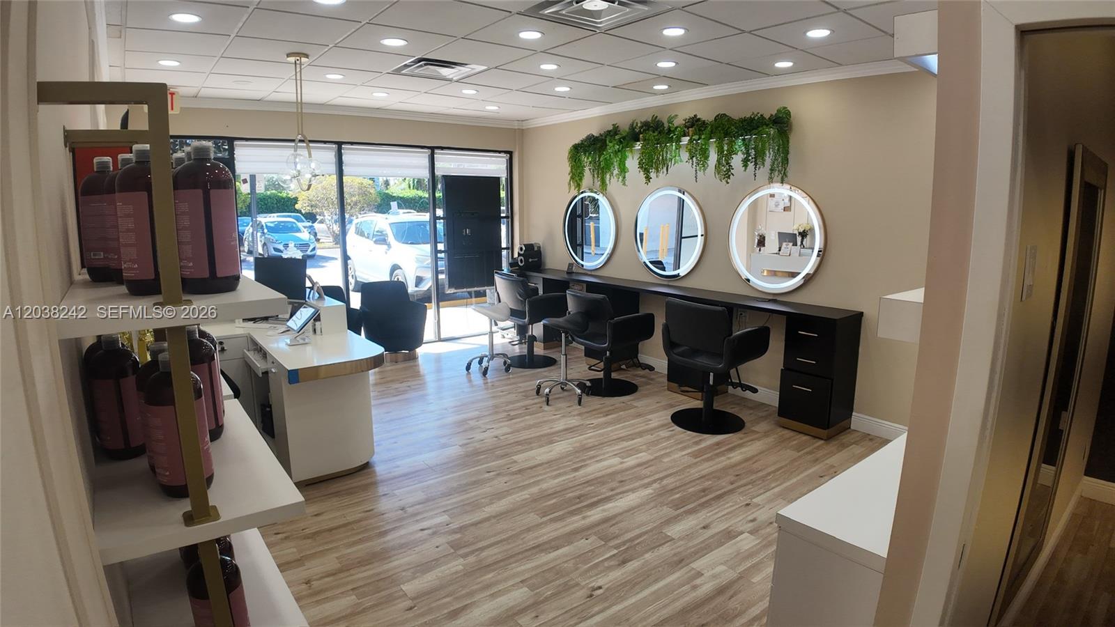 A modern hair salon features three circular mirrors, black styling chairs, and light wood flooring — 4721 NW 79th Ave, Doral FL 33166, DORAL, FL