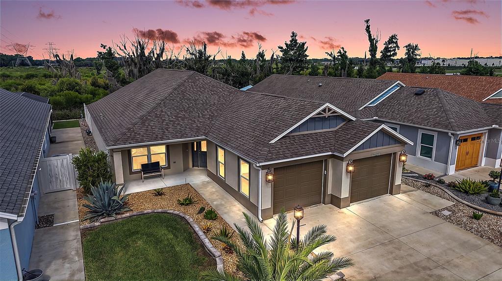An aerial view of a suburban house with a two-car garage and a landscaped yard — 4686 HILES PLACE, THE VILLAGES, FL