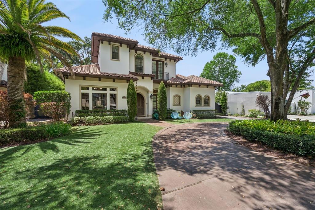 A two-story Mediterranean-style house with a tile roof, stucco exterior, and a paved driveway — 1864 GRINNELL TERRACE, WINTER PARK, FL