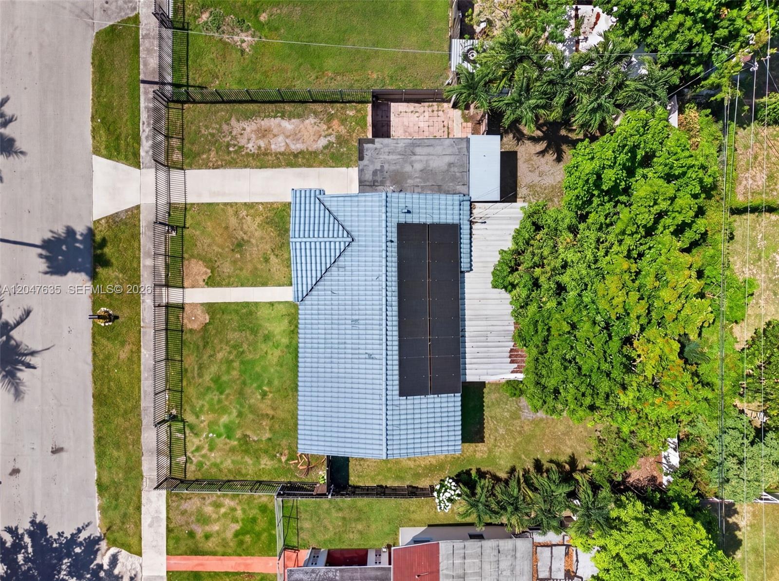 An aerial view shows a house with a blue tiled roof and solar panels — 17841 SW 112th Pl, Miami FL 33157, MIAMI, FL