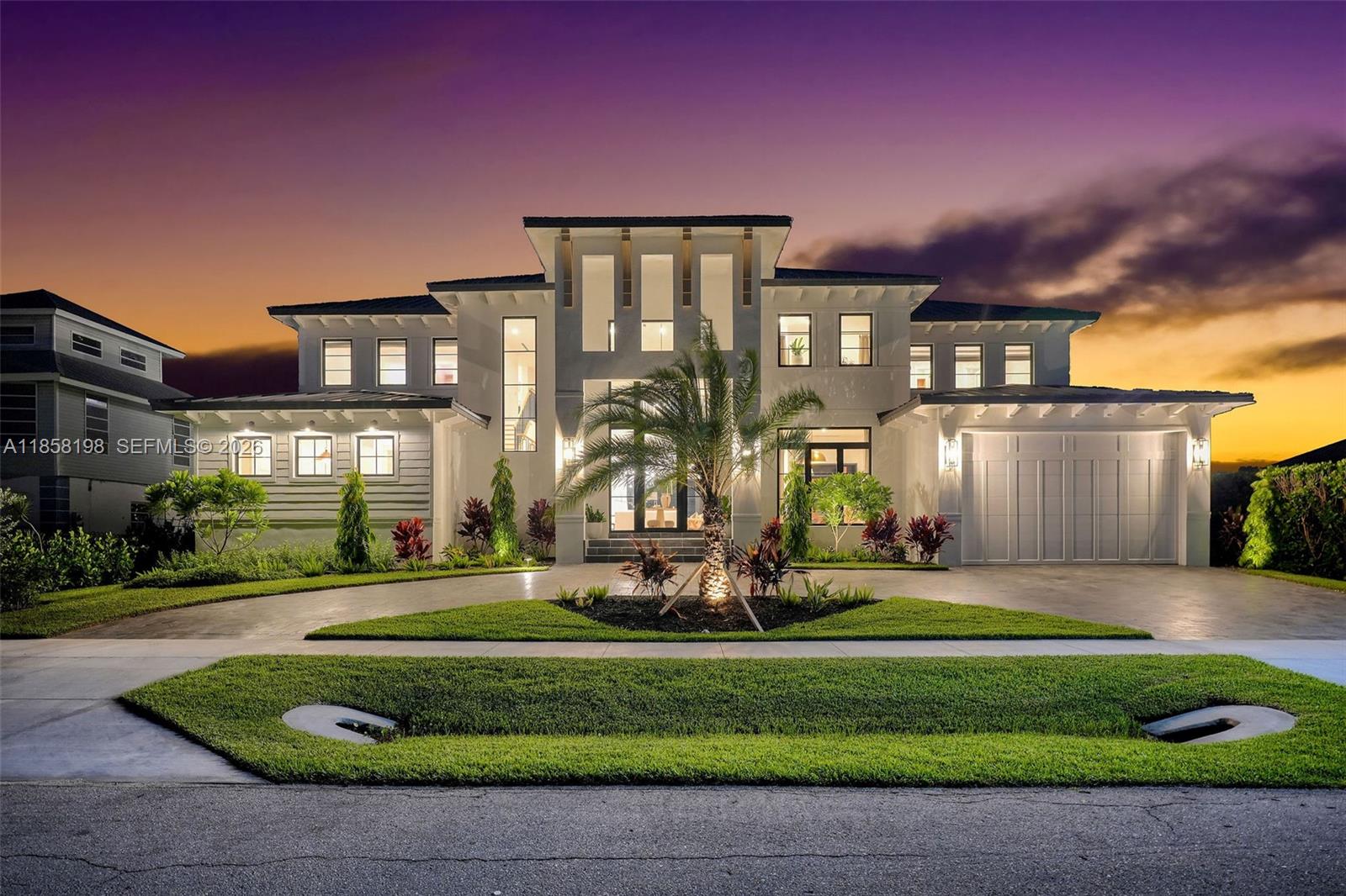 A two-story modern house with a palm tree in the front yard at dusk — 839 Chestnut CT, Marco Island FL 34145, MARCO ISLAND, FL