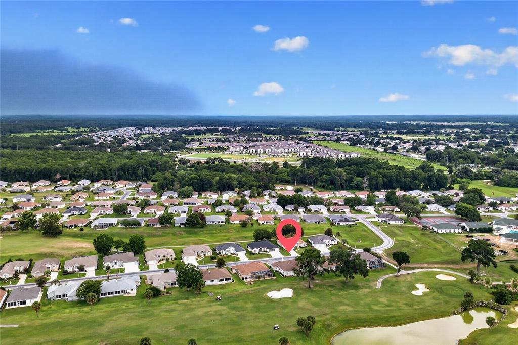An aerial view shows a residential neighborhood with houses situated along a golf course — 2515 NW 53RD AVENUE ROAD, OCALA, FL
