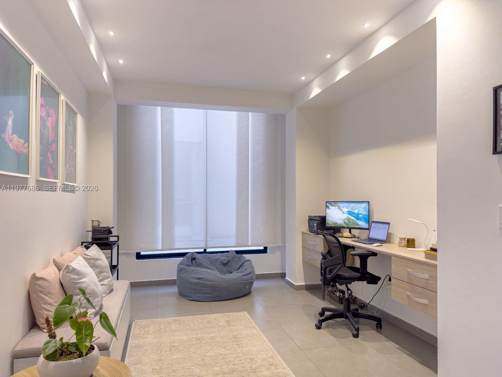 A home office features a built-in desk, a sofa, a beanbag chair, and tiled flooring — 183 Parcelacion El Yarumo, 055010, FL