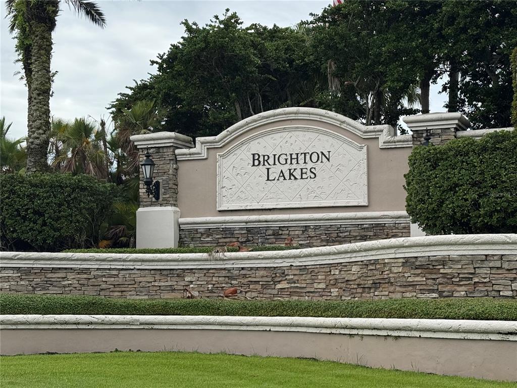 A stone and stucco monument sign for Brighton Lakes stands in a landscaped residential area — 2414 HURON CIRCLE, KISSIMMEE, FL