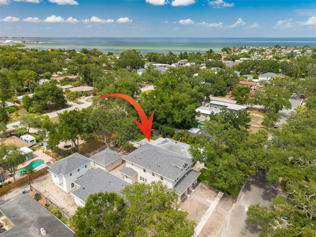A two-story house with light-colored siding, a brick porch, and a central arched entryway — 125 24TH AVENUE SE, ST PETERSBURG, FL