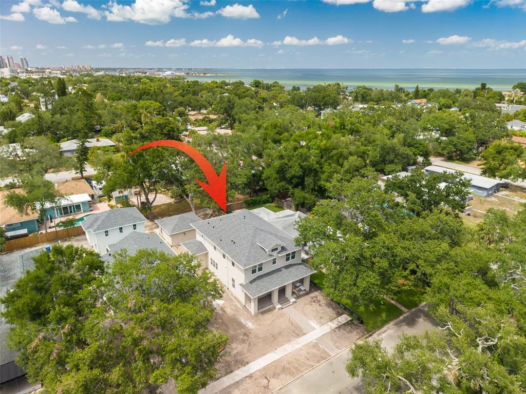 A two-story house with light gray siding, a front porch, and brick columns — 125 24TH AVENUE SE, ST PETERSBURG, FL