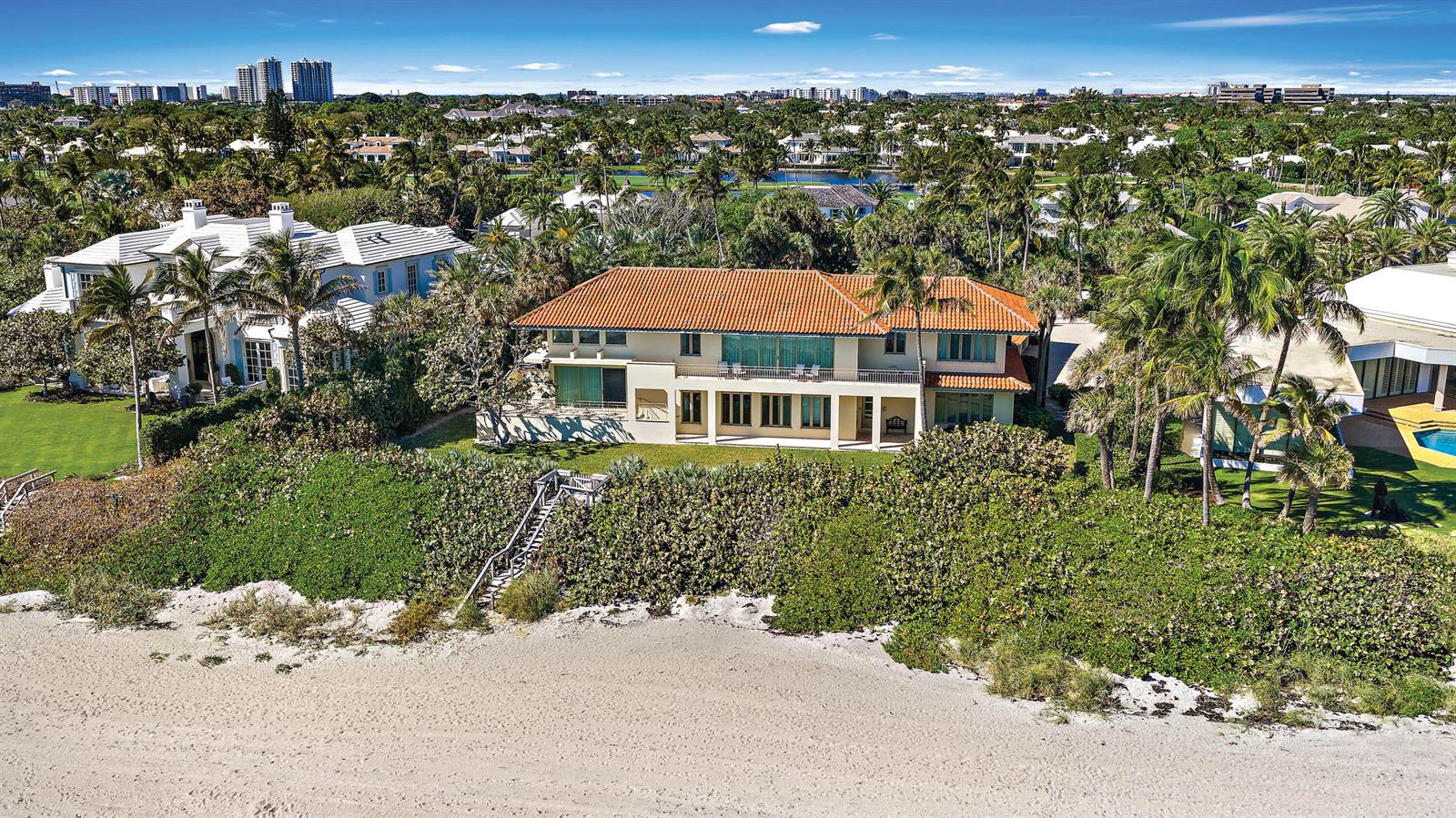 An aerial view of a beachfront house with a red tile roof and palm trees — 11800 Turtle Beach Road, North Palm Beach FL 33408, NORTH PALM BEACH, FL
