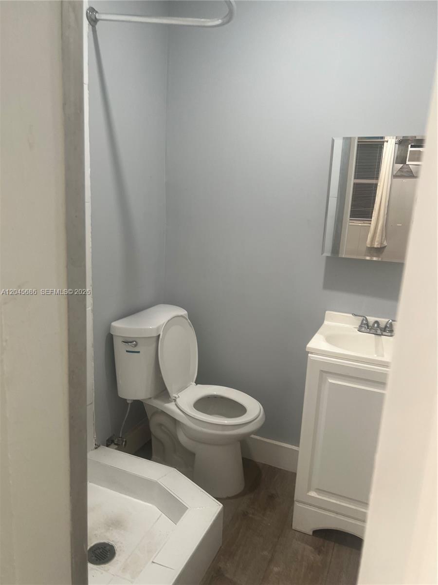 A small bathroom features a toilet, a white vanity, and a corner shower stall — 2118 N 19th Ave # 4, Hollywood FL 33020, HOLLYWOOD, FL