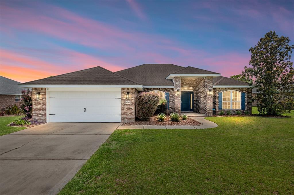 A living room with teal walls, a large bookshelf, a television, and a keyboard — 6746 SE 12TH PLACE, OCALA, FL