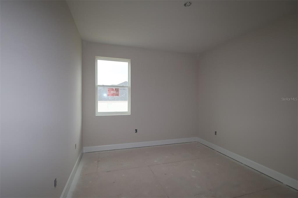 An empty room with light-colored walls, white trim, a single window, and unfinished flooring — 3209 WOLF LAKE AVENUE, APOPKA, FL