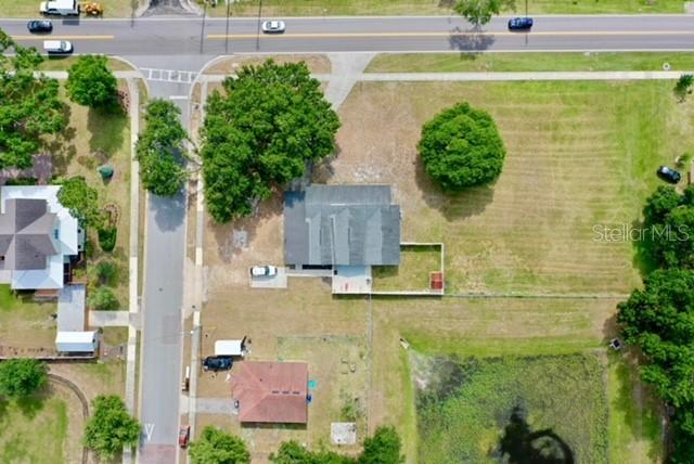 An aerial view shows a house with a fenced yard, nearby roads, and a pond — 273 AVALON ROAD, WINTER GARDEN, FL