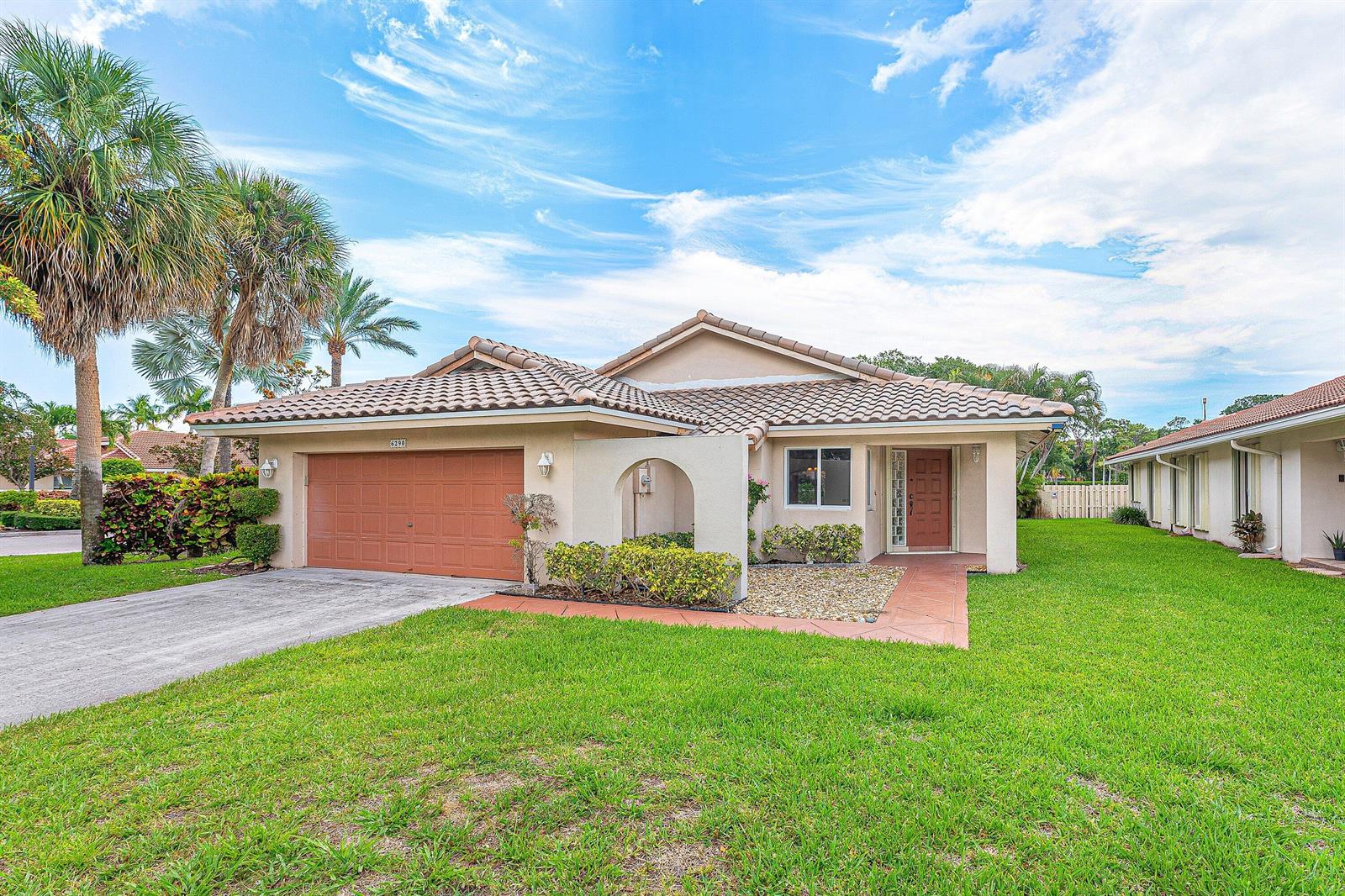 A single-story house with a tile roof, brown garage door, and a front lawn — 6290 Sweet Maple Lane, Boca Raton FL 33433, BOCA RATON, FL