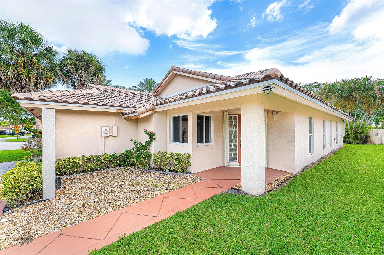A single-story house with a tiled roof, stucco exterior, and a covered front entryway — 6290 Sweet Maple Lane, Boca Raton FL 33433, BOCA RATON, FL