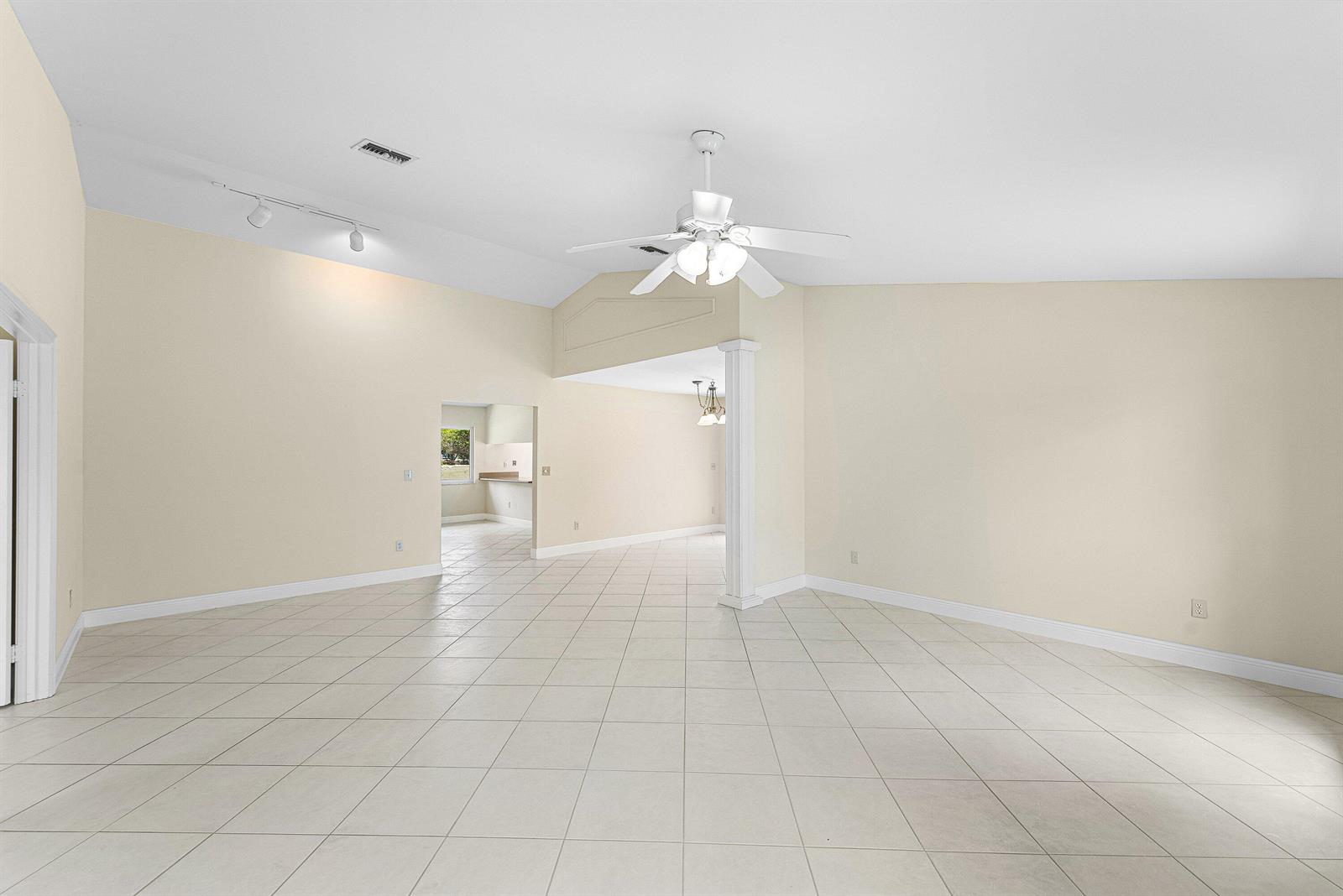 An open living area with vaulted ceilings, tile flooring, and a ceiling fan — 6290 Sweet Maple Lane, Boca Raton FL 33433, BOCA RATON, FL
