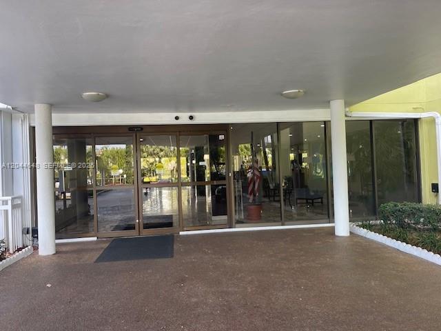 The exterior entrance features a covered drop-off area with glass sliding doors and white columns — 4400 Hillcrest Dr # 701B, Hollywood FL 33021, HOLLYWOOD, FL