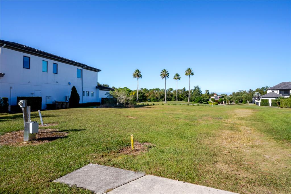 An aerial view shows a vacant residential lot outlined in red between two existing houses — 1188 CASTLE PINES COURT, REUNION, FL