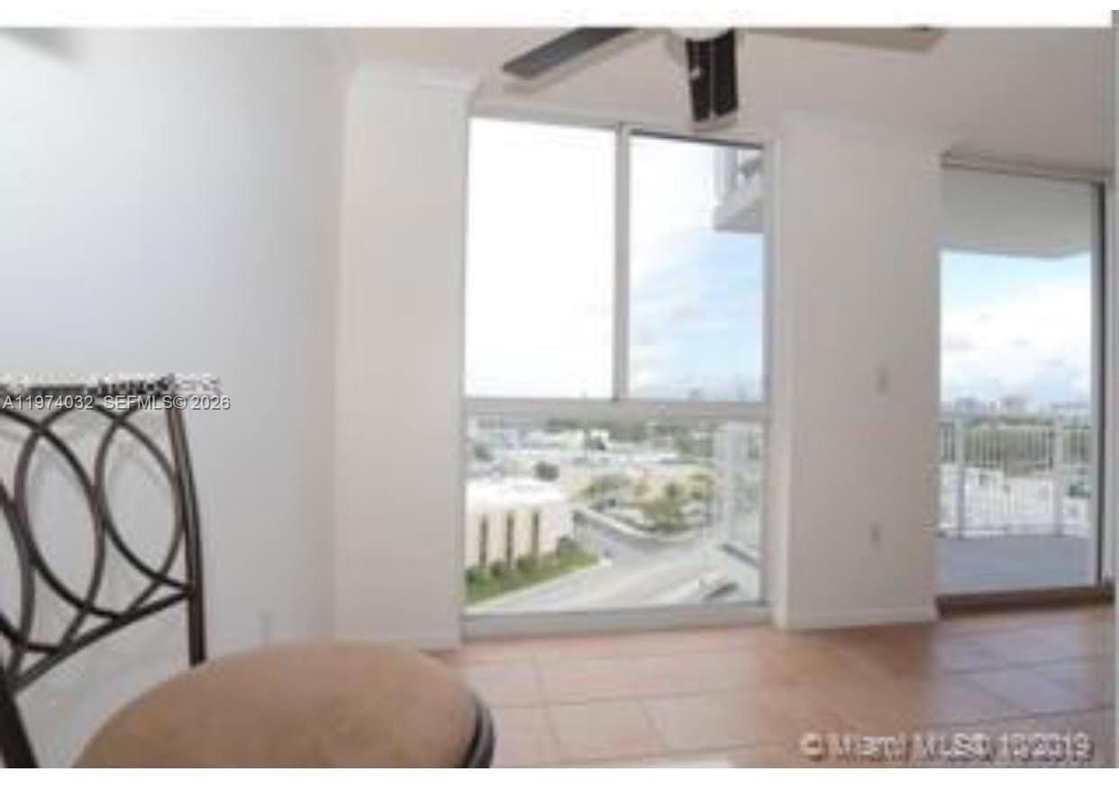 An interior view of a room with tile flooring, a ceiling fan, and large windows — 1688 West Ave # 1107, Miami Beach FL 33139, MIAMI BEACH, FL