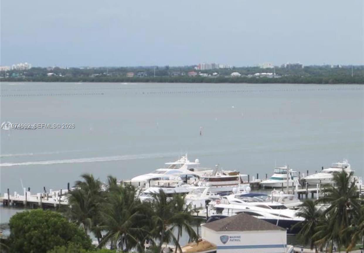 A high-angle view shows a marina with several yachts docked near a coastal shoreline — 1688 West Ave # 1107, Miami Beach FL 33139, MIAMI BEACH, FL