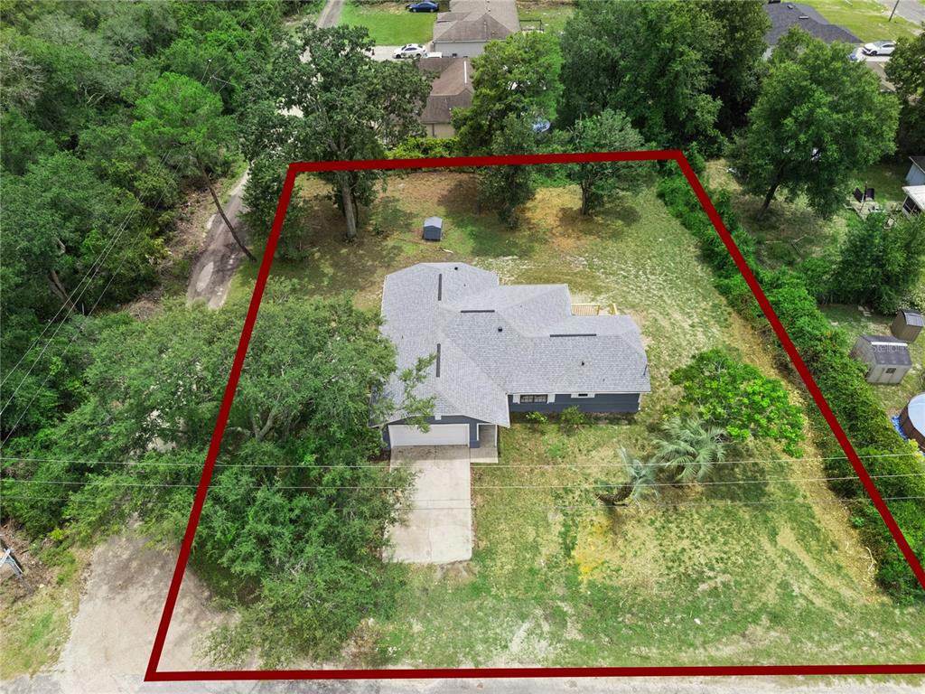 An aerial view shows a single-story house with a gray roof on a large lot — 1110 CATHERINE STREET, ORANGE CITY, FL
