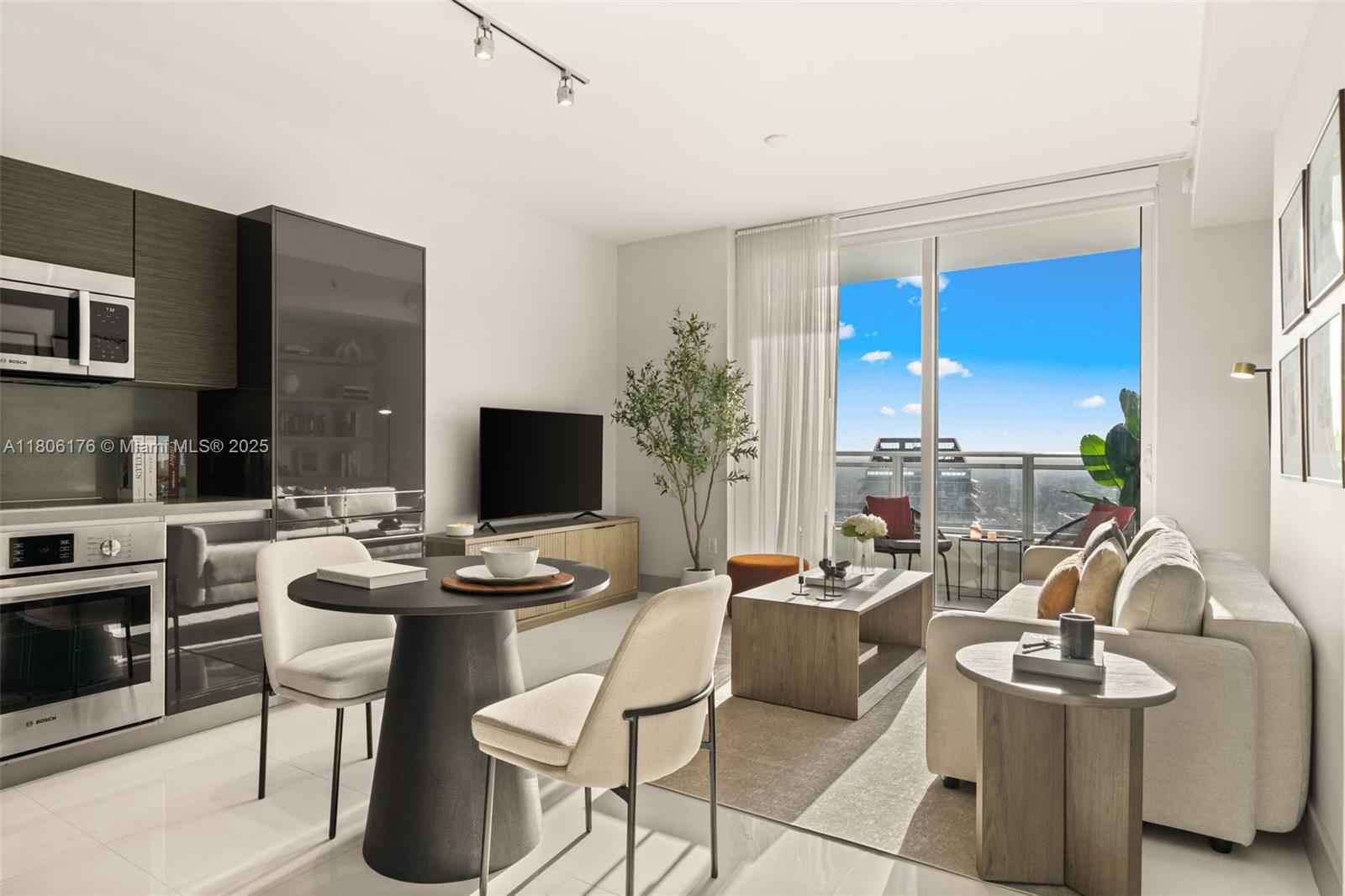A modern apartment living area features a kitchen, dining table, and balcony with city views — 1080 Brickell Ave # 3905, Miami FL 33131, MIAMI, FL