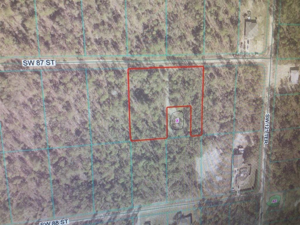 This is an aerial map showing a vacant lot outlined in red with an "X" marking a specific area — 0 SW 87 STREET, DUNNELLON, FL