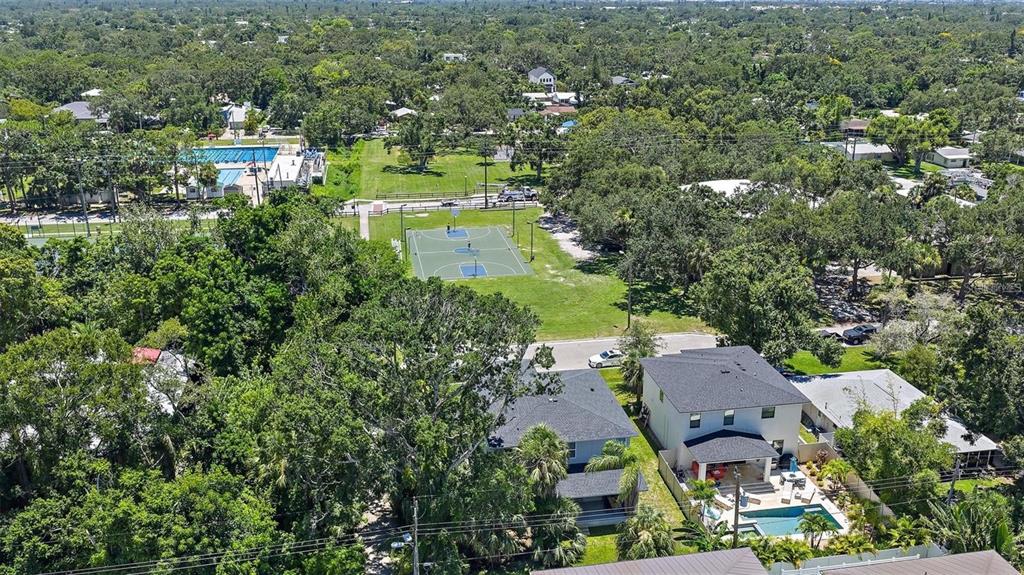 An aerial view shows a residential neighborhood with a basketball court and a swimming pool — 2587 TEMPLE STREET, SARASOTA, FL