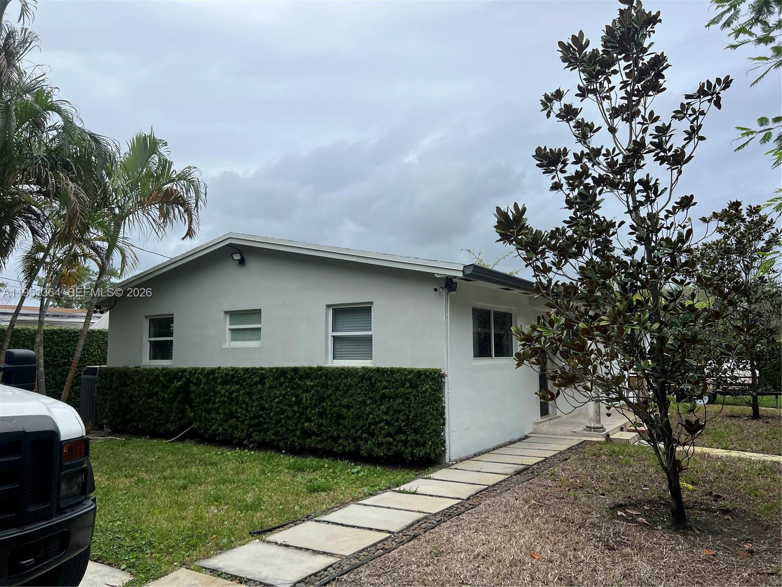 A single-story house with a light gray exterior, a hedge, and a stone walkway — 4250 SW 71st Ave, Miami FL 33155, MIAMI, FL