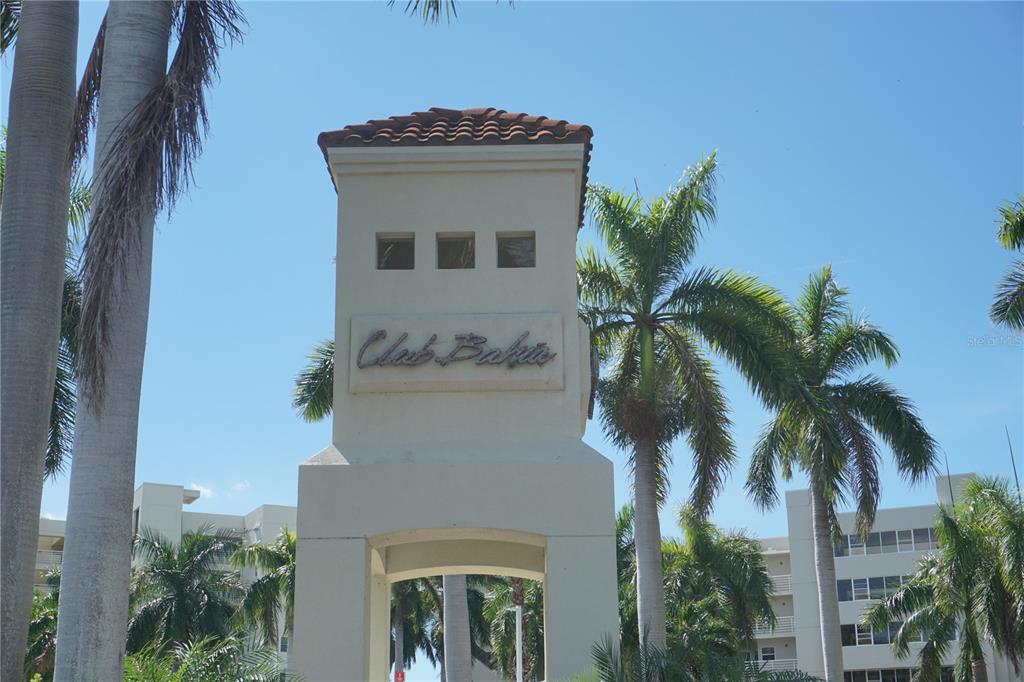 A tall, beige stucco entrance monument with the name Club Bahia stands among palm trees — 6093 BAHIA DEL MAR CIRCLE UNIT 277, ST PETERSBURG, FL