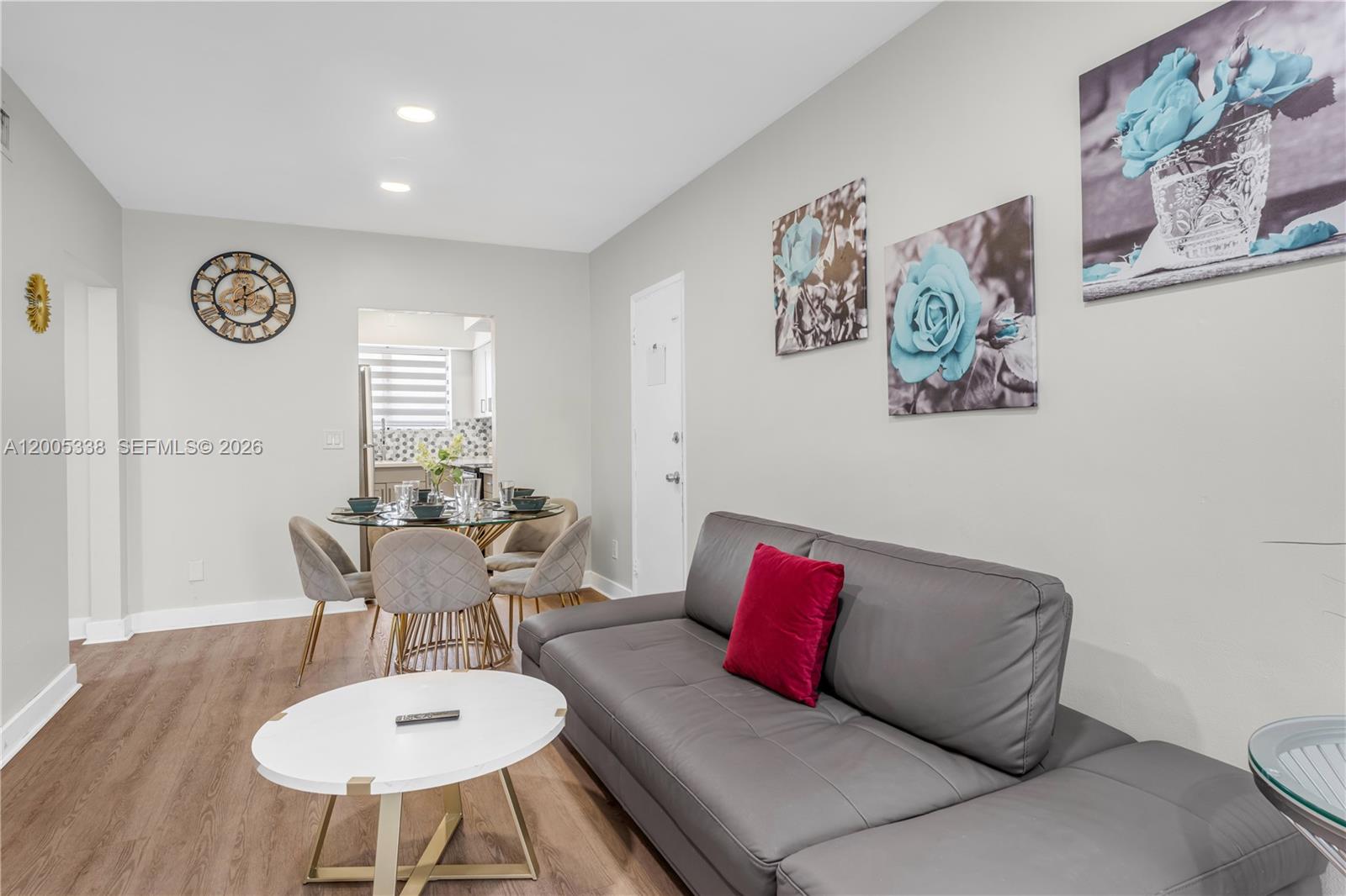 A living room features a grey sofa, a white coffee table, and a dining area — 10006 E Bay Harbor Dr # 16, Bay Harbor Islands FL 33154, BAY HARBOR ISLANDS, FL