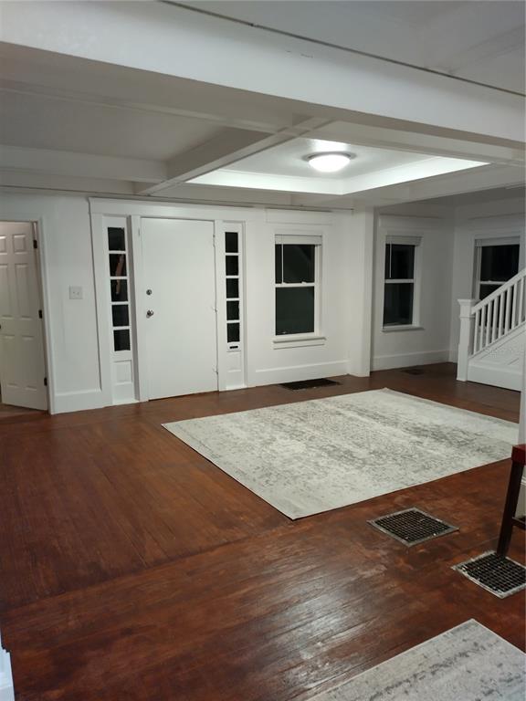 A living room features hardwood floors, a white front door, and a coffered ceiling — 405 S RIDGEWOOD AVENUE, DAYTONA BEACH, FL