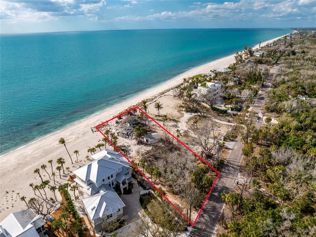 An aerial view shows a beachfront lot with debris and a small structure outlined in red — 7380 MANASOTA KEY ROAD, ENGLEWOOD, FL