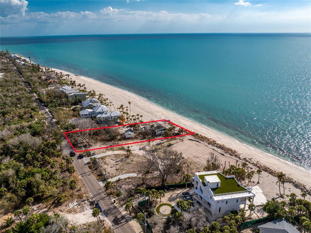 An aerial view shows a beachfront property lot outlined in red along the coastline — 7380 MANASOTA KEY ROAD, ENGLEWOOD, FL