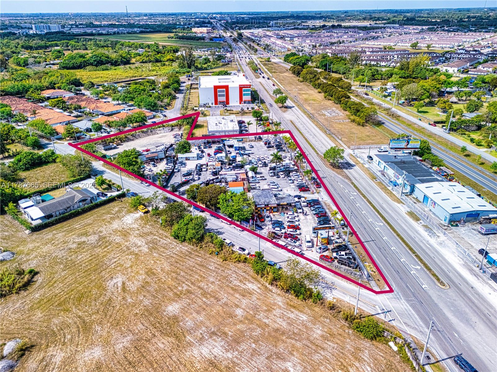 An aerial view shows a triangular commercial lot with a car dealership and parking area — 22825 S Dixie Hwy, Miami FL 33170, MIAMI, FL