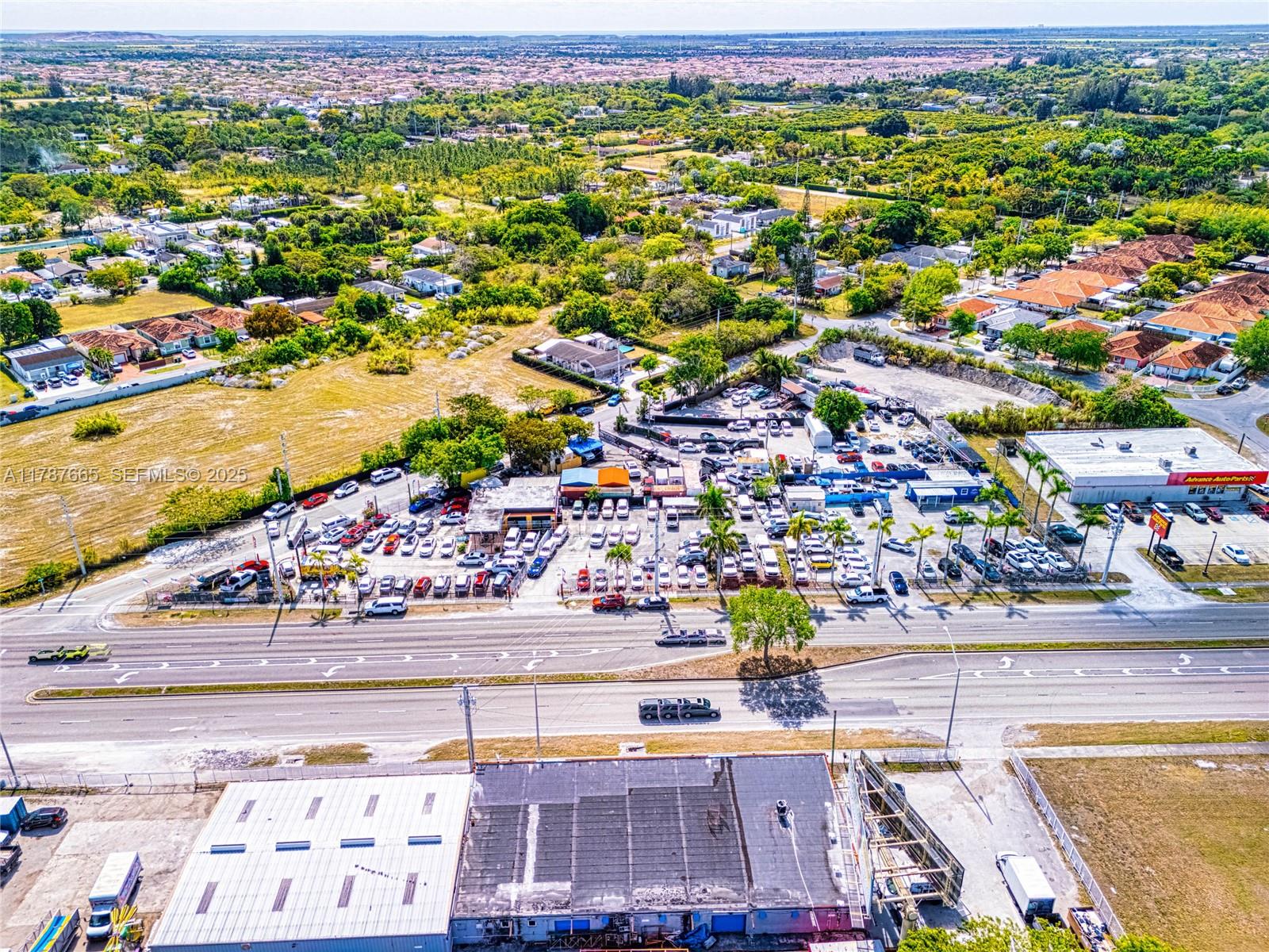 An aerial view shows a commercial car lot and adjacent buildings near a busy road — 22825 S Dixie Hwy, Miami FL 33170, MIAMI, FL