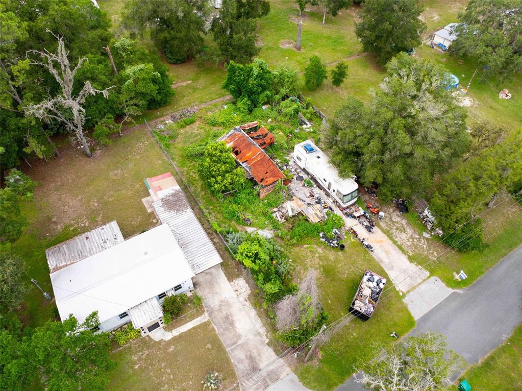 An aerial view shows a house, a dilapidated structure, and a parked RV on a lot — 7080 N PEARL POINT, HERNANDO, FL