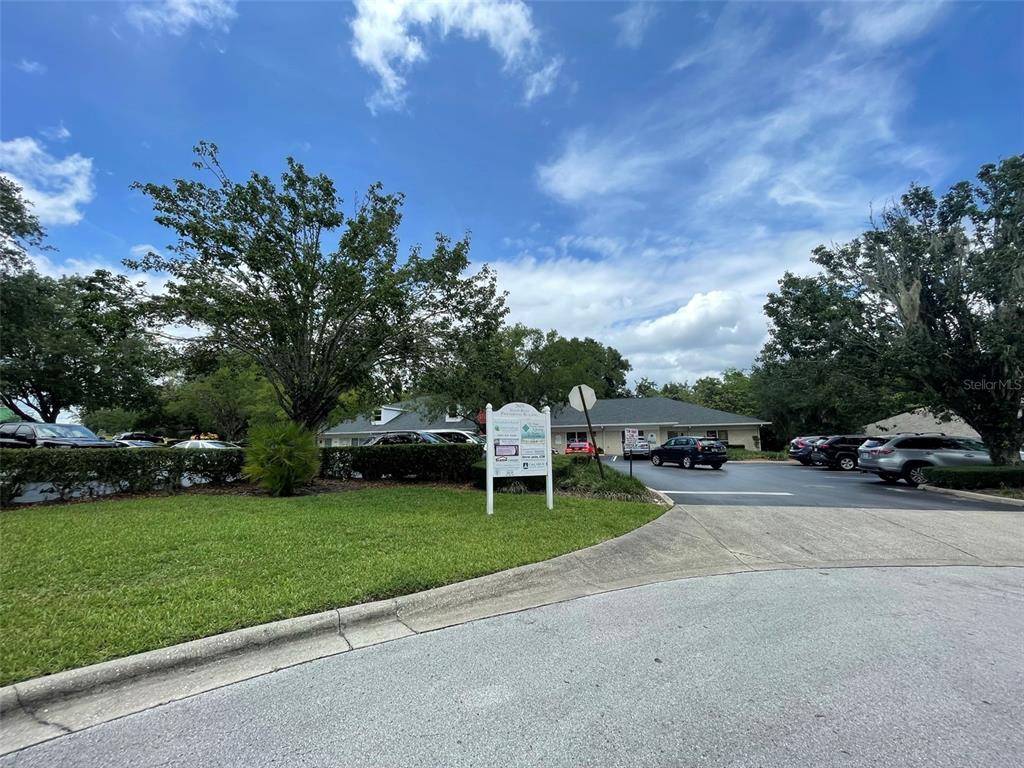 A single-story commercial building with a parking lot and a sign in the foreground — 2609 SW 33RD STREET UNIT 102-3, OCALA, FL