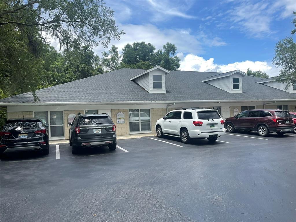 A single-story commercial building with a gray shingled roof and a paved parking lot — 2609 SW 33RD STREET UNIT 102-3, OCALA, FL