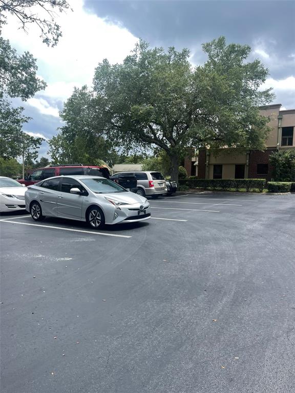 A parking lot with several parked cars sits in front of a multi-story building — 2609 SW 33RD STREET UNIT 102-3, OCALA, FL