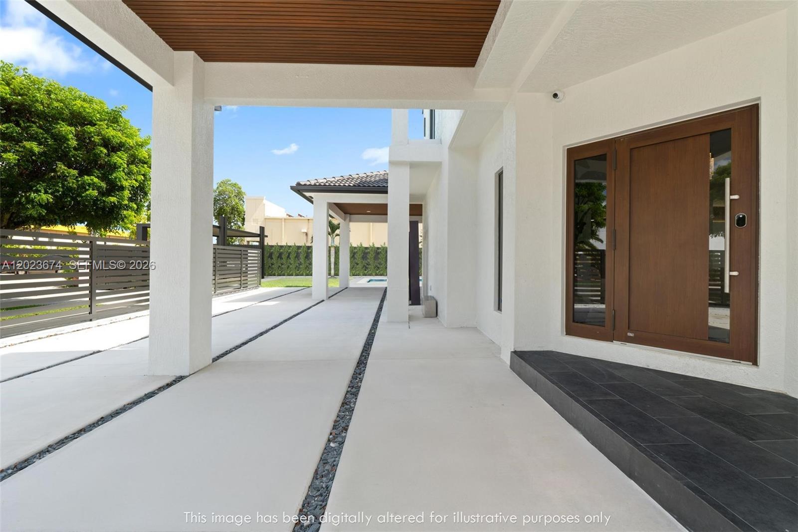 A covered outdoor walkway leads to a modern front entrance with a wooden door — 4014 SW 144th Pl, Miami FL 33175, MIAMI, FL