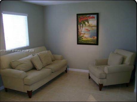 A living room features a beige sofa and armchair on a light-colored tiled floor — 3680 Oak Ave # 6, Miami FL 33133, MIAMI, FL
