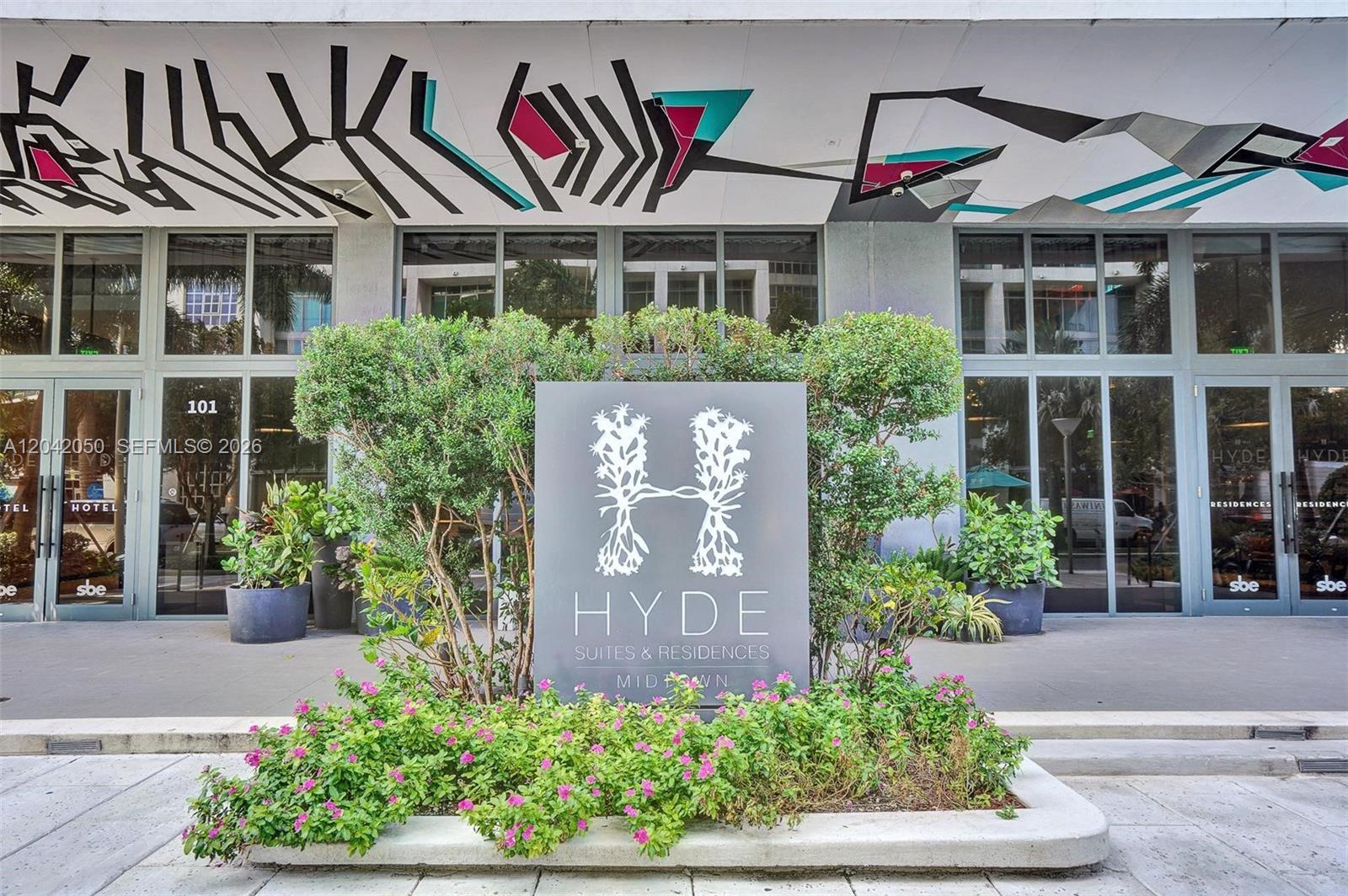 The exterior entrance of a building features a large Hyde Suites & Residences sign — 121 NE 34th St # 2205, Miami FL 33137, MIAMI, FL