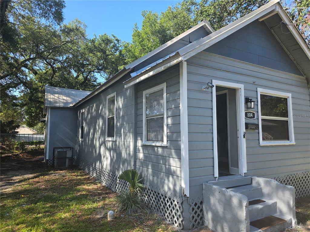 A gray, single-story house with horizontal siding, a metal roof, and lattice skirting — 804 W 29TH STREET, JACKSONVILLE, FL