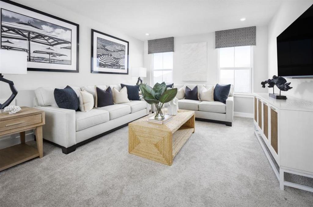 A living room features two white sofas, a woven coffee table, and framed wall art — 3165 MADRAS DRIVE NW, PALM BAY, FL