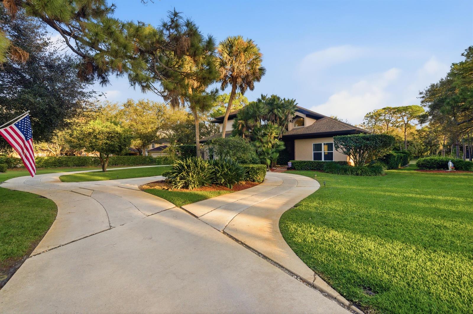 A house with a circular driveway and an American flag in the front yard — 4838 Charlton Way, Delray Beach FL 33445, DELRAY BEACH, FL