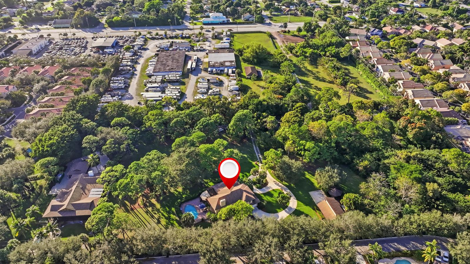 An aerial view shows a house with a swimming pool surrounded by trees and landscaping — 4838 Charlton Way, Delray Beach FL 33445, DELRAY BEACH, FL