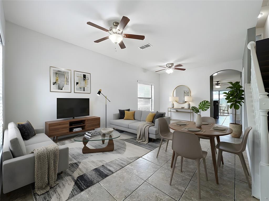 A living and dining area with gray sofas, a wood media console, and tile flooring — 1360 WINDSOR LAKE CIRCLE, SANFORD, FL