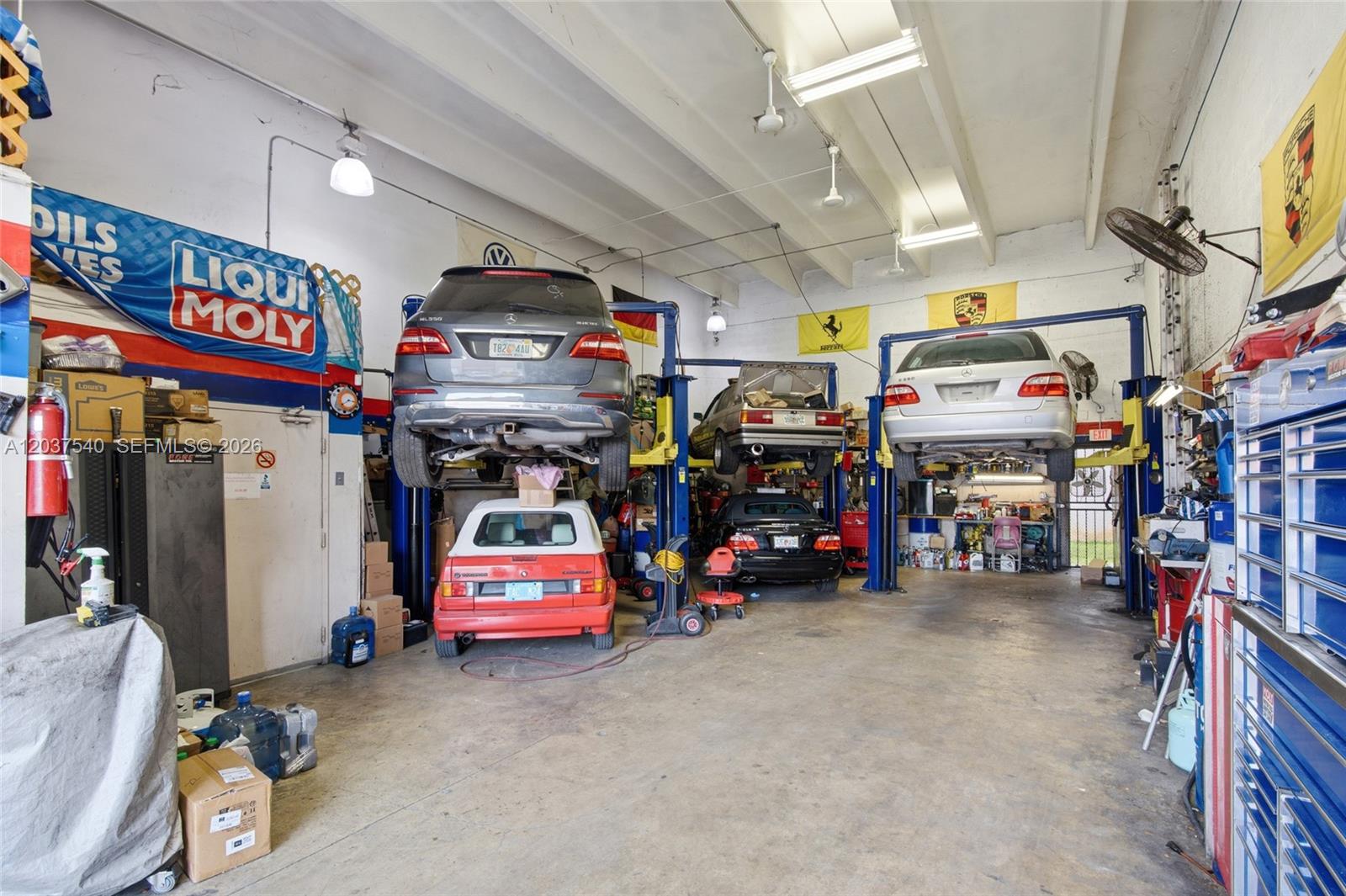 A professional automotive repair shop features three vehicles on lifts and various tools and equipment — 11950 SW 144th Ct # 3, Miami FL 33186, MIAMI, FL