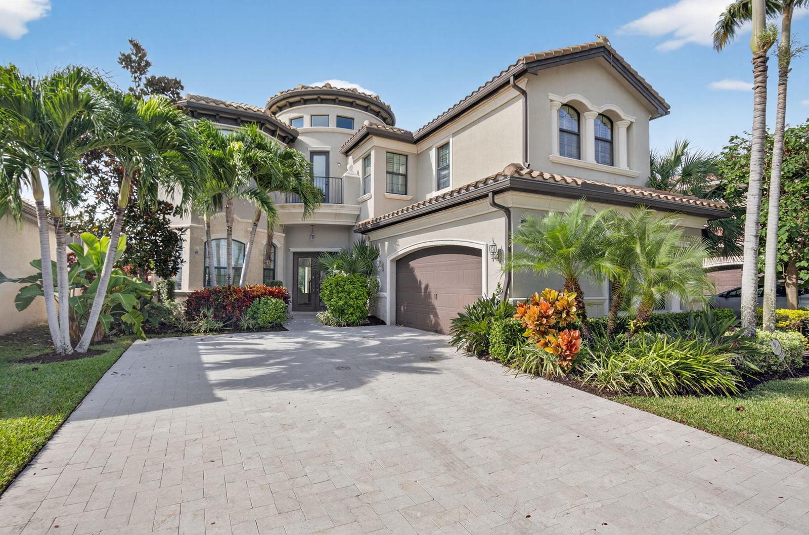 A two-story stucco house with a tile roof, arched windows, and a paved driveway — 16801 Pavilion Way, Delray Beach FL 33446, DELRAY BEACH, FL