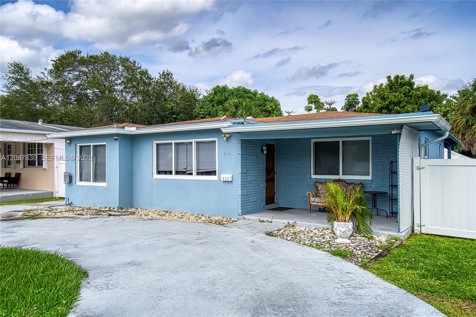 A light blue single-story house with a concrete driveway and a covered front porch — 644 SW 7th Ct # 0, Hallandale Beach FL 33009, HALLANDALE BEACH, FL