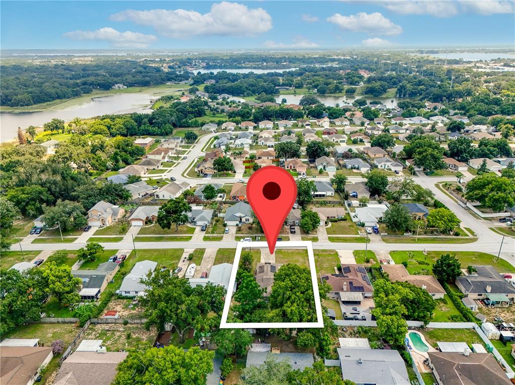 An aerial view shows a residential property highlighted with a white border and location pin — 407 SOUTH AVENUE, EUSTIS, FL